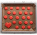 Röda vackra kakor på bakplåtspapper på en ugnsplåt