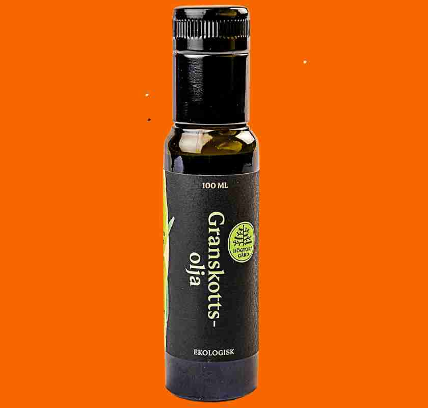 Flaska Granskottsolja fr�n H�gtorp g�rd mot orange bakgrund