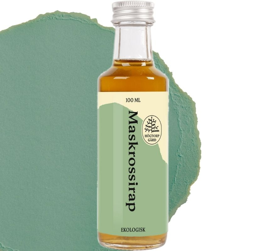 Maskrossirap fr�n H�gtorp G�rd i glasflaska, gr�n grafisk bakgrund