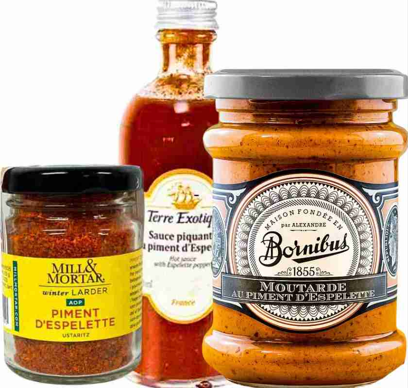 Tre produkter med espelettepeppar. Ren espelette, espelettesenap och en chilis�s med espelette