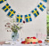 Flaggspel med svenska flaggor i tyg ovanför bord med tårta
