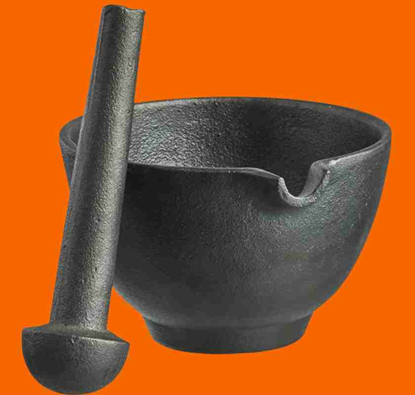 Mortel i gjutj�rn med st�t mot orange bakgrund