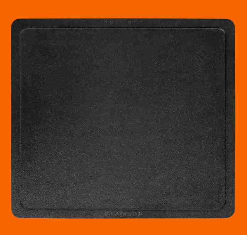 Stekbord i gjutj�rn Gourmet ovanifr�n mot orange bakgrund