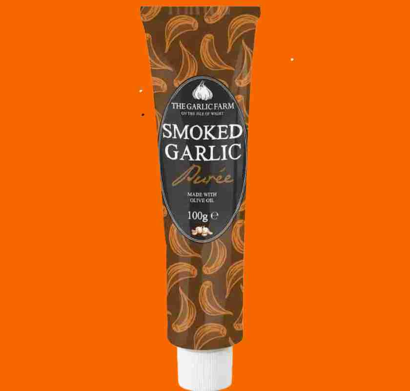Smoked Garlic pur� i tub mot orange bakrund