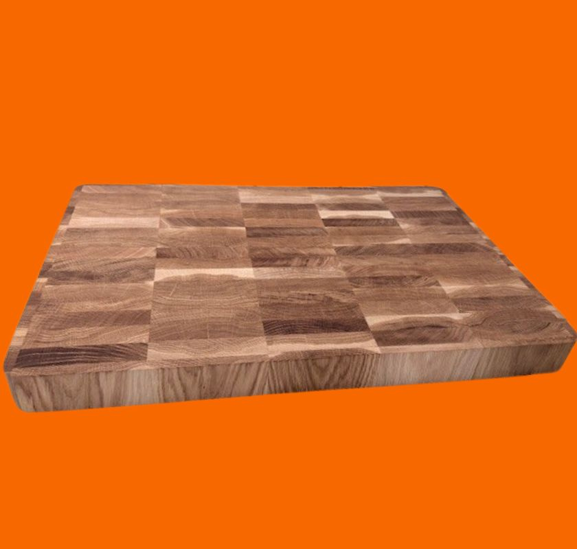 Skärbräda i ek av ändträ 60 cm x 40 cm 5 cm hög mot orange bakgrund